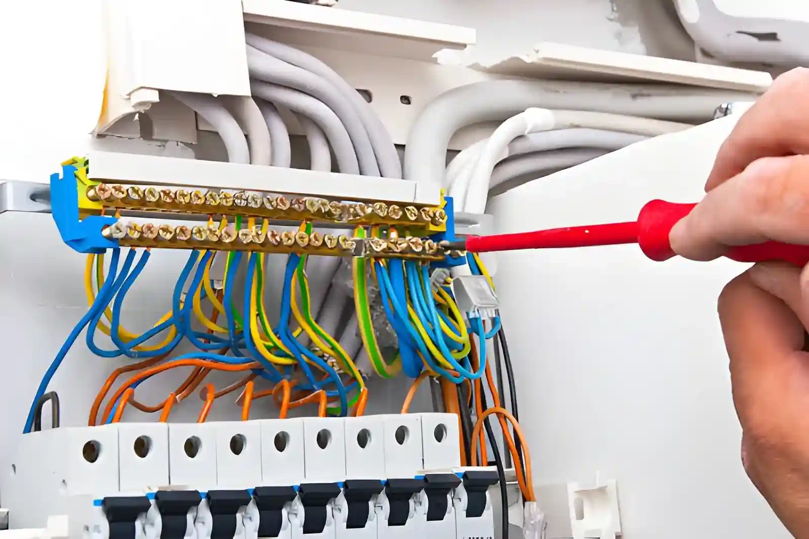 Electrician installing a new fuse box safely