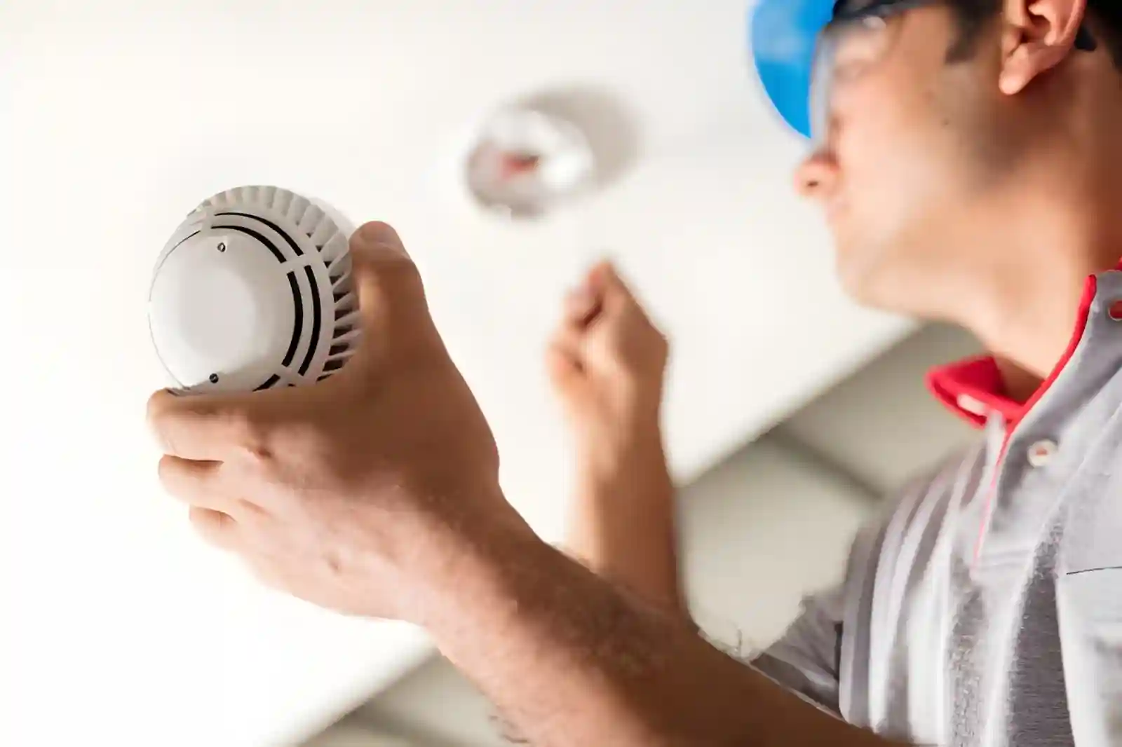 Technician checking commercial fire alarm installation system